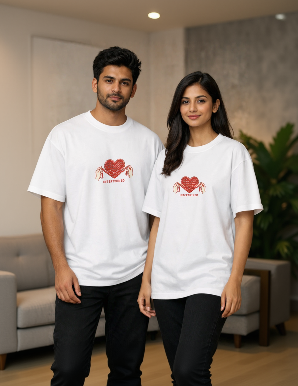 Two people wearing white t-shirts with a red heart design and text.